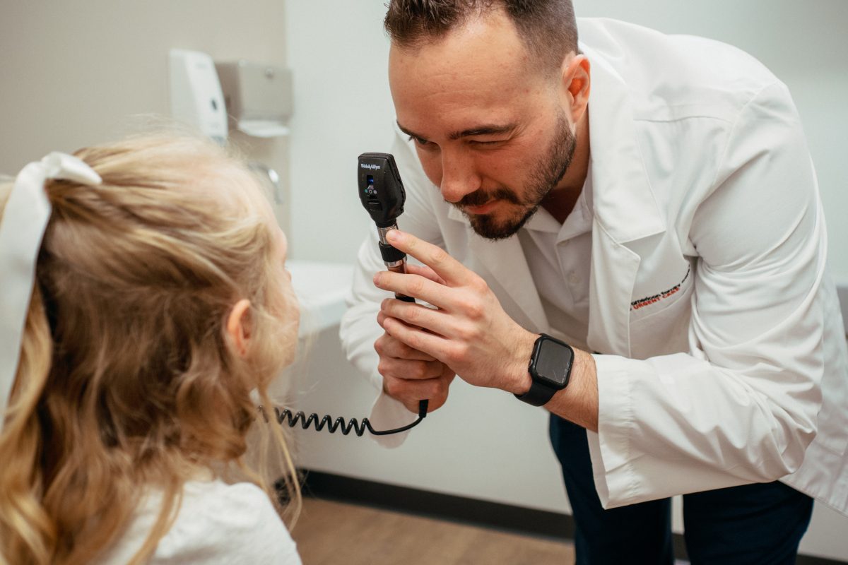 AFC provider examining child patient AFC provider examining child patient