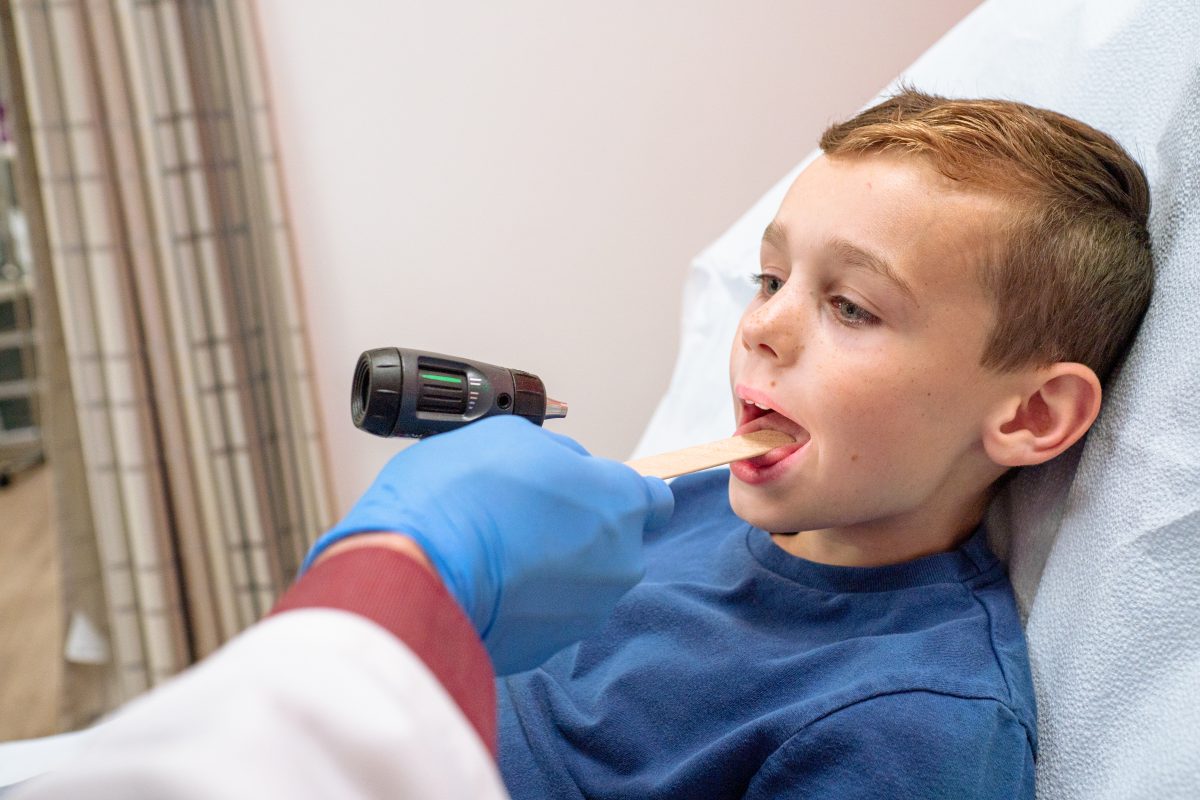 Doctor examining a patient for strep throat